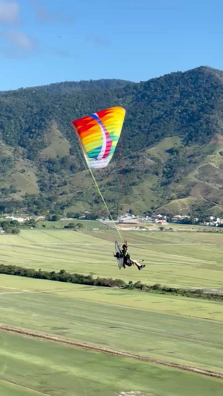 Paramotor over green mountains