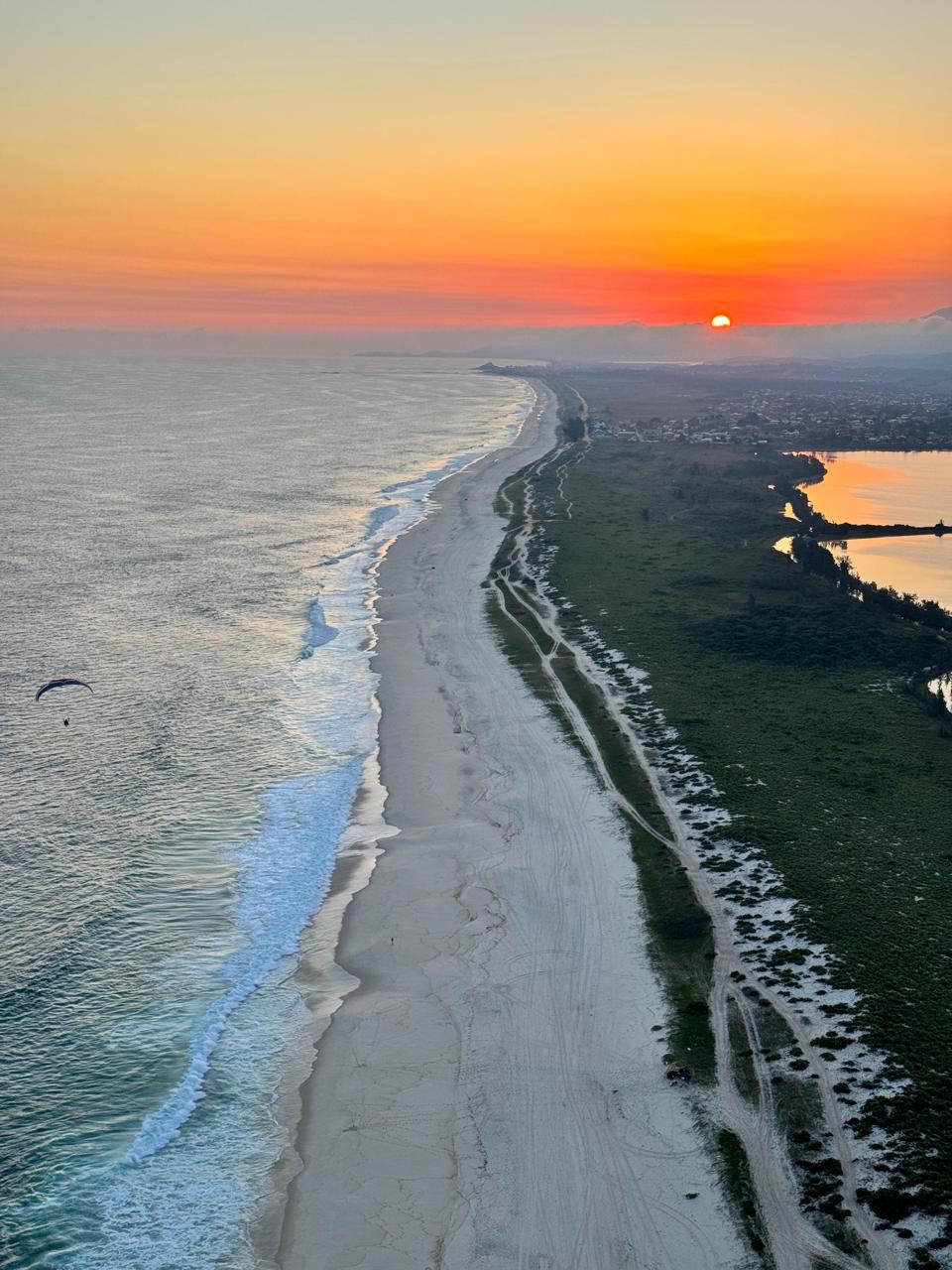 Aerial view of Rio coastline at sunset from paramotor
