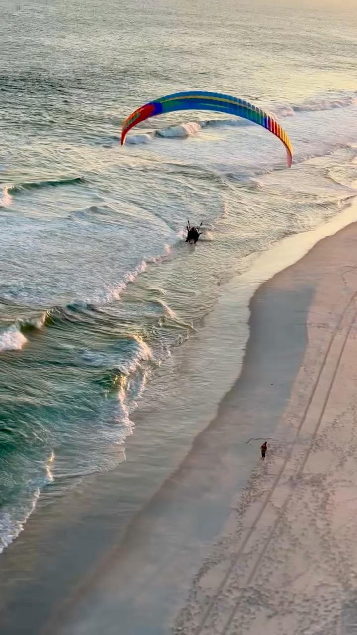 Paramotor over ocean waves